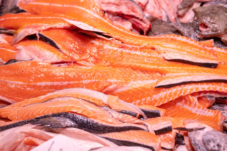 Close up shot of a lot of red salmon fillet meat on ice at the street market.の写真素材