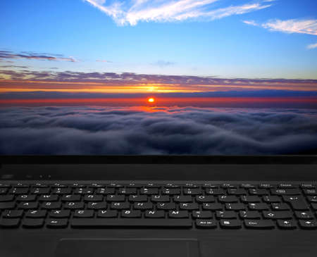 laptop keyboard and beautiful sunset displayの写真素材