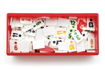 rummy pieces in box on white