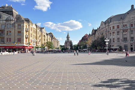 Timisoara, Timis, Romania - June 21, 2015: People walking in the city center of Timisoara, Victory Square or Opera Square - the symbol of the Romanian revolution in 1989, with The Metropolitan Orthodox Cathedral in background.のeditorial素材