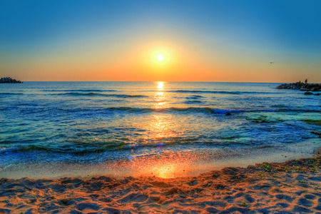 Beautiful background with colorful sunrise over the sea in Costinesti beach, Constanta - Romaniaの写真素材