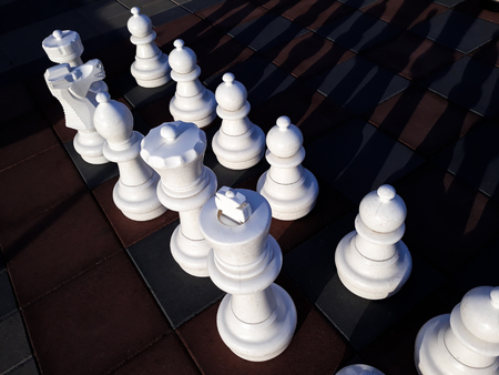 Giant chess pieces on board outdoor, at sunsetの写真素材