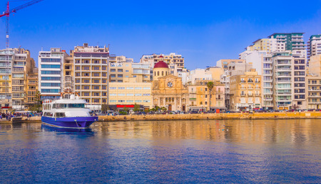 Beautiful panoramic view over the famous harbor of Valletta illuminated by sunset light, in Maltaのeditorial素材