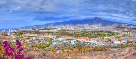 Beautiful panorama from the air from Chayofita mountain peaks over the comercial area and Los America Golf in Tenerife, Canary island of Spainの写真素材