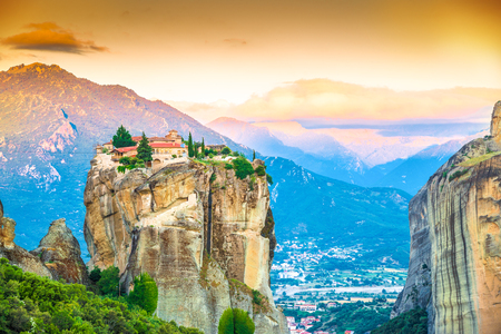 Beautiful landscape at sunrise with traditional mountain and Holy Trinity monastery in Meteora place,  Greece, Europeの写真素材