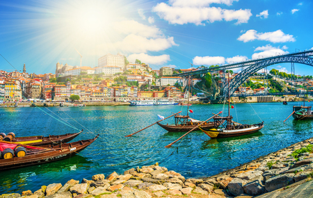 Dom Luis I bridge and traditional boats on Rio Douro river in Porto, Portugalの写真素材