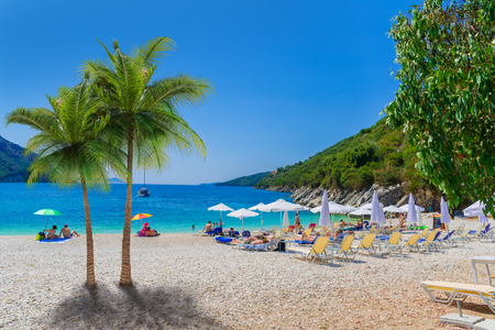 Beautiful summer holiday scene of Mikros Poros Gialos beach with people enjoying vacation in Lefkada island, Greeceの写真素材