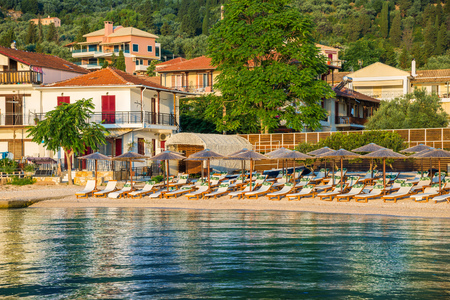 Chairs and umbrellas on Nikiana beach at sunrise, in Lefkada island, Greeceの写真素材