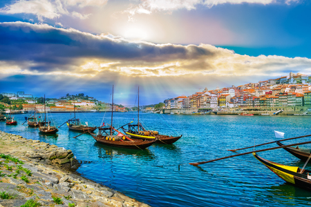 Cityscape over architecture and traditional boats on Rio Douro river in Porto city, Portugalの写真素材