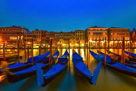 Beautiful postcard from Venice, with gondolas on grand canal at blue hourの写真素材