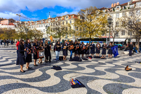 Lisbon, Portugal - March 19, 2018: Young group of children singing in the main square of Lisbon, playing divers instruments, celebrating the musical day of the cityのeditorial素材