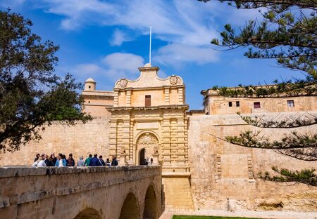 Mdina, Malta - March 25, 2017: People visiting historical architecture of the famous bridge and old citadel of Mdina, in a sunny dayのeditorial素材