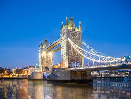 Famous place in London, Tower Bridge over Thames river illuminated at dusk to down in Englandの写真素材