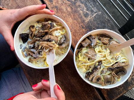 Fresh coocked mushrooms pasta on wooden rustic tableの写真素材