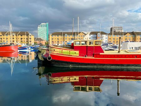 Red boats on Thames river in South Londonの写真素材
