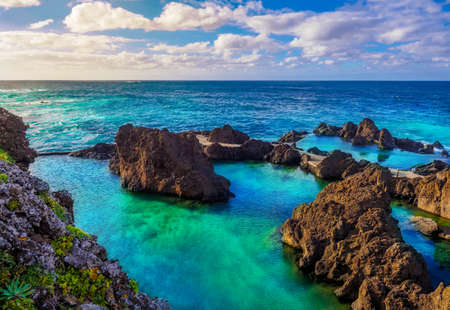Landscape with natural volcanic formation pools on the coast of Porto Moniz in Madeira island, Portugalの写真素材