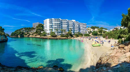 Panoramic view of Cala Ferrera beach with people on seaside in summer holiday on Mallorca island, Spainのeditorial素材