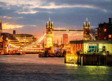 Cityscape view of the City of London and the famous iconic landmark Tower Bridge illuminated in evening lights, in Englandの写真素材