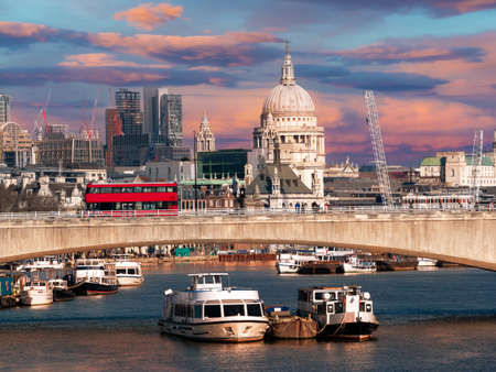 Cityscape of London with the historical bridge and Saint Pauls Cathedral architecture and traditional boats on the River Thamesの写真素材
