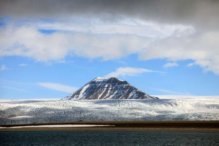 Glacier front and mountain peaks in Svalbard, Norwayの写真素材