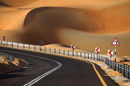Desert road and dunes in Liwa, United Arab Emiratesの写真素材