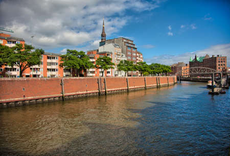 Downtown Hamburg on a cloudy day. Tourist boats passing on the waterways.の写真素材