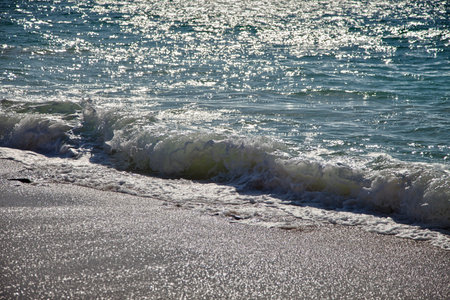Surf breaking on the sandy beach