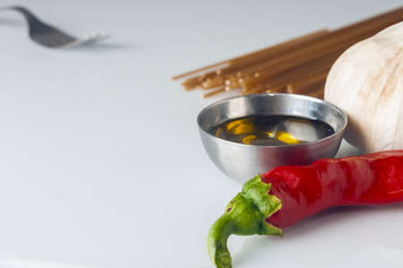 Garlic oil and chili spaghetti igredient on white backgroundの写真素材