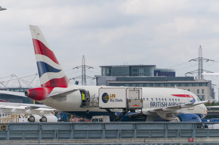 LONDON, UNITED KINGDOM - AUGUST 02, 2013 A British Airways airplane loading catering before take off in London City Airportのeditorial素材
