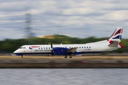 LONDON, UK - AUGUST, 2 2013; A Bristish Airways Saab 2000 (G-CDEB) take off from London City Airportのeditorial素材