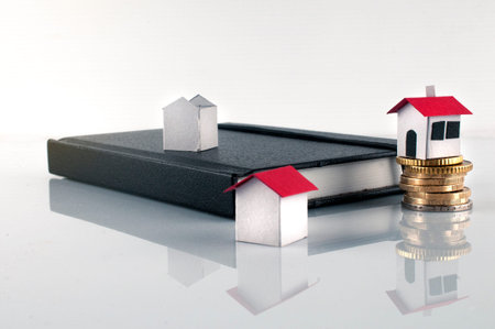 Three paper house, some coin and a diary: mortgage, loans and refurbishing conceptの写真素材