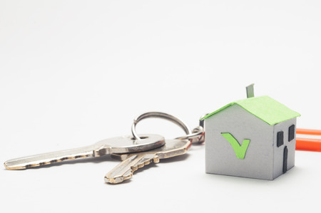 Mortgage concept: keys with plastic tag and a green paper houseの写真素材