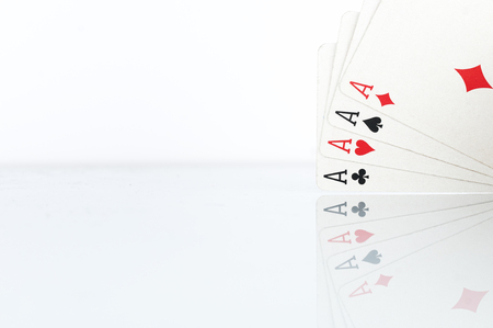 Four of a kind aces macro shot on white background with reflectionの写真素材