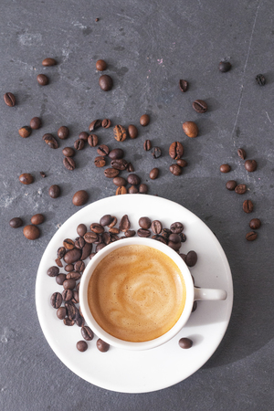 Coffee cup top view with some coffee beansの写真素材