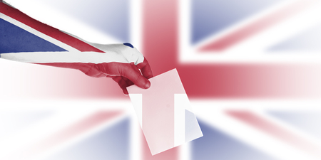 Hand putting voting card for local elections in ukの写真素材
