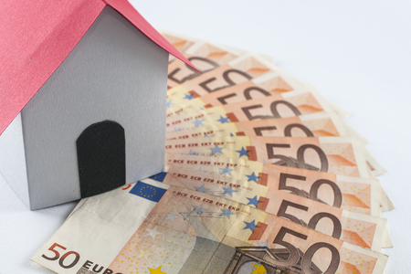 Mortgage and loan concept: paper house on a fifty euros banknote fanの写真素材