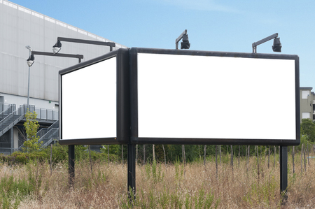 Blank billboard with lights in a fieldの写真素材