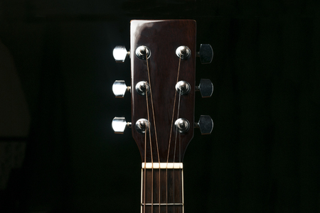 Acoustic guitar wooden neck on black backgroundの写真素材