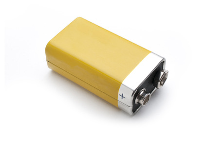 A blank yellow 9v battery isolated on white backgroundの写真素材