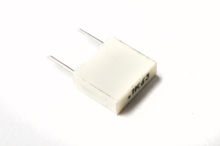 A 100nf film capacitor on white backgroundの写真素材