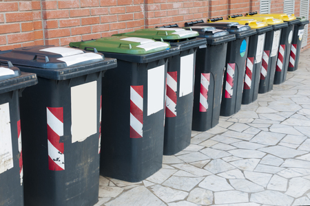 Row of bins for the separate collection of glass, paper and aluminum outside a buildingの写真素材