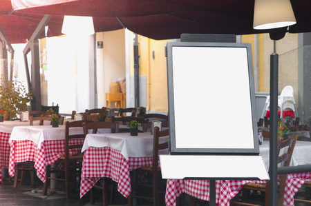 Italian street restaurant with blank menu board on a standの写真素材