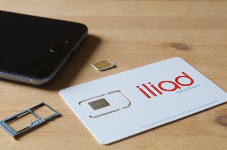 CARRARA, ITALY - JUNE 25, 2019 - A sim card of the French operator Iliad, recently active in Italy ready to be inserted into a smartphoneのeditorial素材
