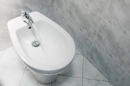 Bidet with running water top down, with copy space. The bidet was invented in France in the 1700sの写真素材