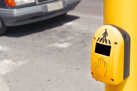 Pedestrian crosswalk button with a car on background, lot of copy spaceの写真素材
