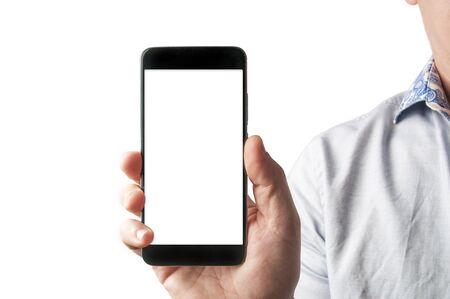 Business man in blue shirt hold a blank screen smartphone in front of the camera on white backgroundの写真素材
