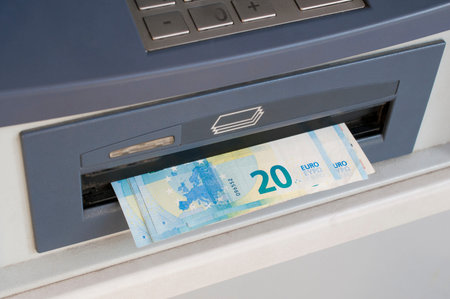 Euro banknotes dispensed from an ATM machine (bancomat)
