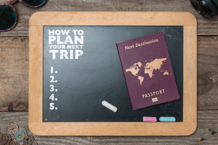 Chalkboard showing tips to plan a trip. Black chalkboard with sunglasses, lens and some chinese...
