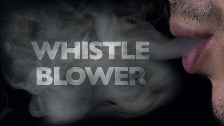 Whistleblowing concept: man blows smoke from his mouth, on which appears the inscription wistle blowerの写真素材