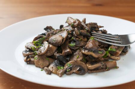 Sauteed champignon mushroom with chopped parsleyの写真素材